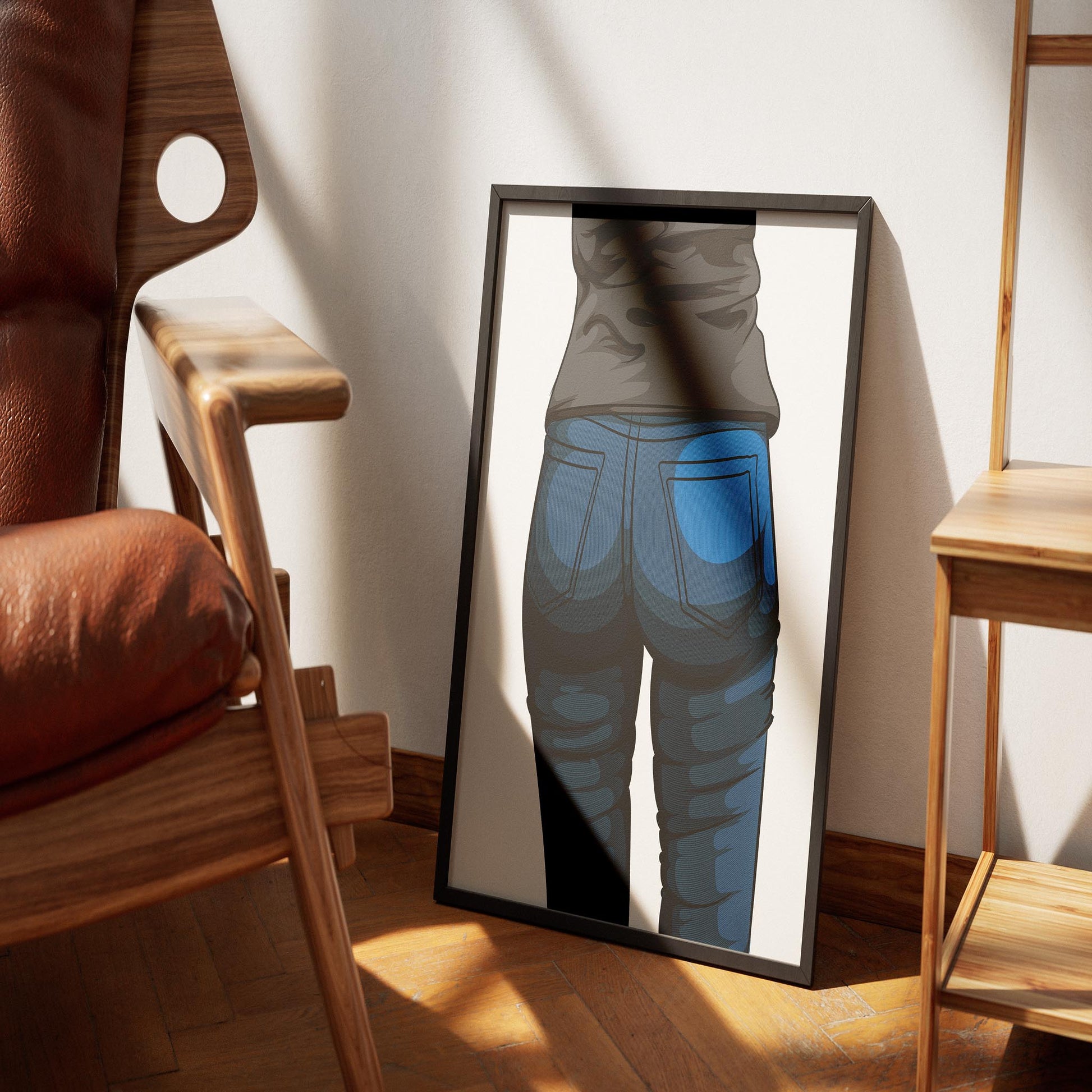 Digitalized denim artwork framed on floor with chair and bookshelf nearby.